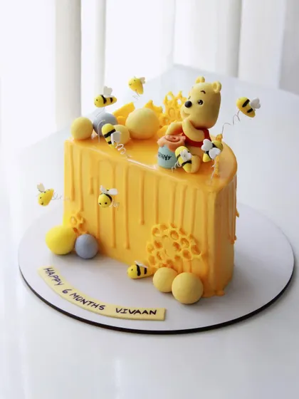 A different angle of the adorable Winnie the Pooh half birthday cake.
