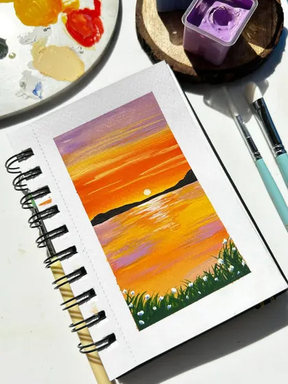 A simple yet beautiful sunset over the water, painted with gouache in my sketchbook.
