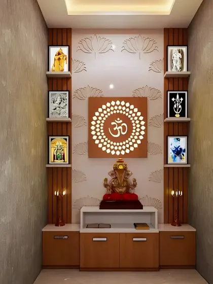 This compact pooja room design utilizes a textured back wall with a lotus motif and a central backlit OM panel. Wooden shelves on either side provide symmetrical display space for framed deities, while the base cabinet offers practical storage for prayer items.