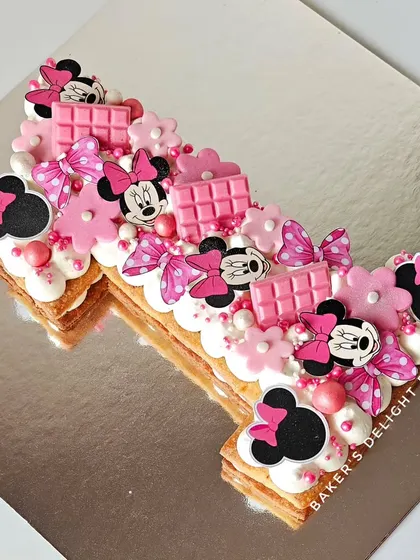 Another angle of the Minnie Mouse number tart, showing the layers of creamy mousse and the detailed decorations.
