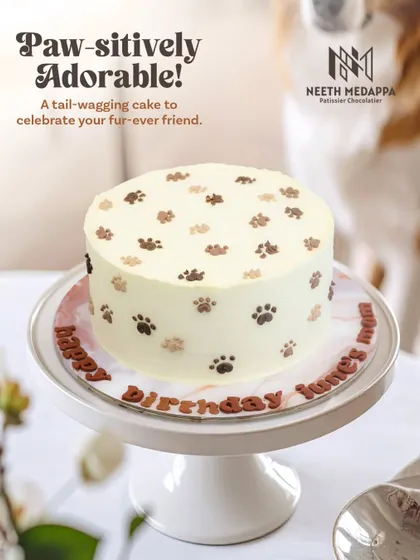 Paw-sitively adorable! A tail-wagging cake to celebrate a fur-ever friend's mom, covered in cute little paw prints.