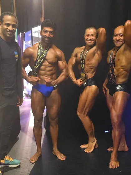 With fellow competitors from around the world. The natural bodybuilding community is built on mutual respect and hard work.