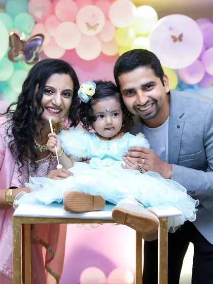 A happy family of three celebrating a first birthday. We love capturing the joy and love in these special family portraits.