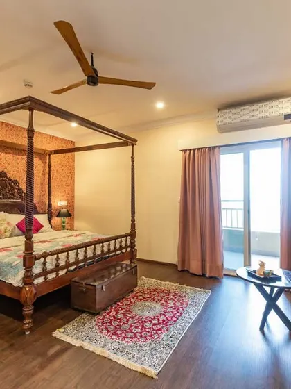 This angle of the master bedroom shows the seating nook by the balcony, creating a perfect spot to relax and enjoy the view.