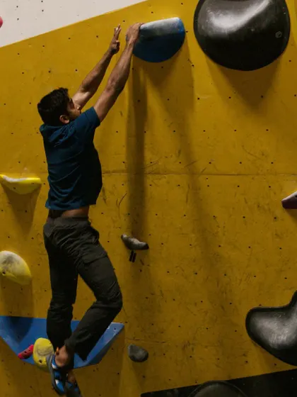 A glimpse from our first exclusive Dyno session. This climber is mid-air, reaching for the next hold in a display of pure athleticism.