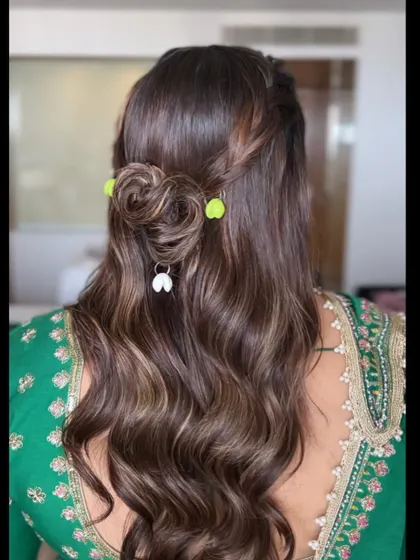 Another angle of the creative Dandiya hairstyle, showing the combination of braids, a bun, and fun accessories.