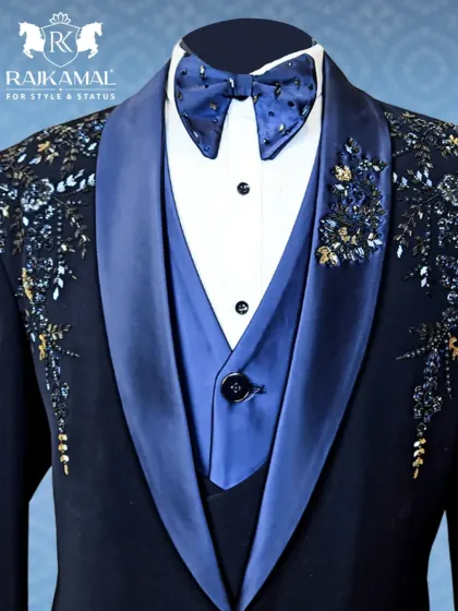A close-up of my signature navy blue tuxedo, showing the embellished bow tie and the intricate floral beadwork on the satin lapel.