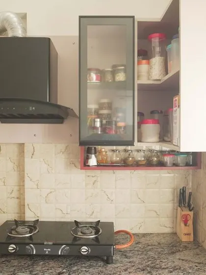 This L-shaped kitchen from a 3BHK apartment features a unique combination of materials and colors. The design was part of a larger project that included custom wardrobes and study units.