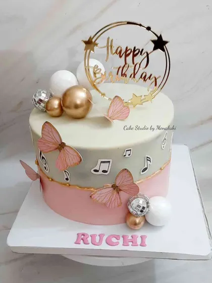 This cake was designed for someone who loves music and butterflies. The two-tone pink and grey design is decorated with musical notes, pink butterflies, and disco balls for a touch of sparkle.