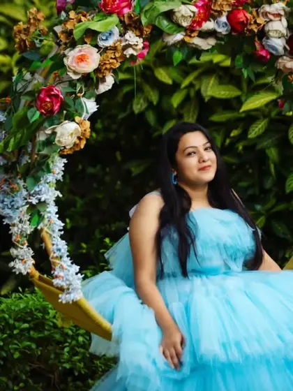 A moment of pure serenity. This stunning sky blue ruffle trail dress looks like it was made for this beautiful garden swing setting.
