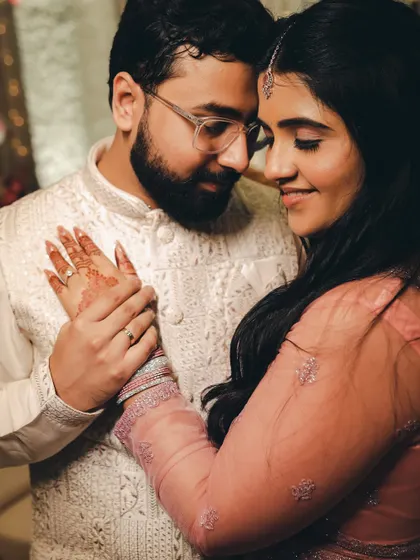 A close-up of the couple in a tender embrace, their hands intertwined. This shot focuses on their connection and the small, intimate gestures that define their love.