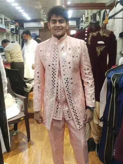 Our mirror work achkans are designed to make you shine. This light pink jacket is a festive and popular choice for grooms and groomsmen, reflecting light beautifully and ensuring you stand out at any celebration.