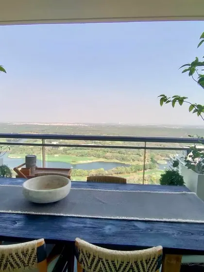 A balcony garden is useful year round. This one, with its large dining table and potted trees, is perfect for enjoying the winter sun or a summer morning breeze.