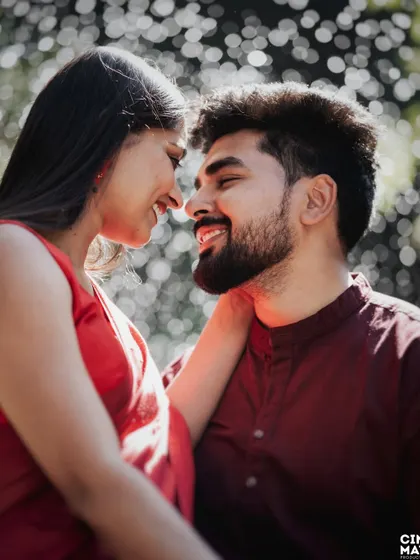 An intimate close-up where the couple is lost in their own world. The soft focus and warm tones highlight their connection and the genuine smiles they share.