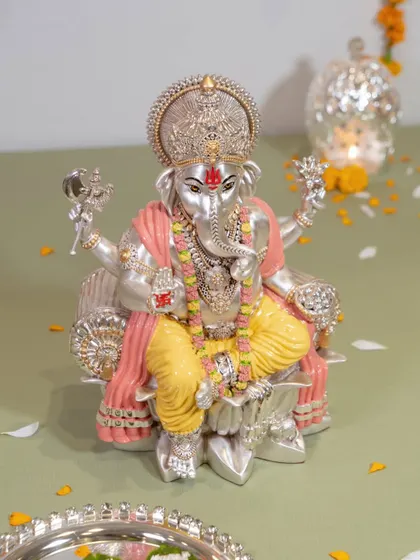 A closer look at the divine craftsmanship of our colored Ganesh idol. The intricate details on the crown and garments, combined with the serene expression, make it a truly special piece for your home.