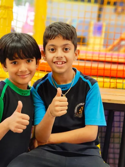 Two students give a thumbs up, showing their approval of the Zooper experience. Happy kids are my specialty.