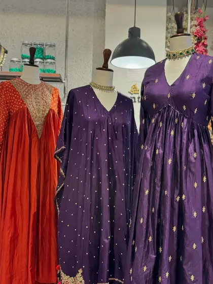 A full view of the orange and purple suits, showcasing their easy, flowing silhouettes. These are perfect for enjoying the festivities without feeling restricted.
