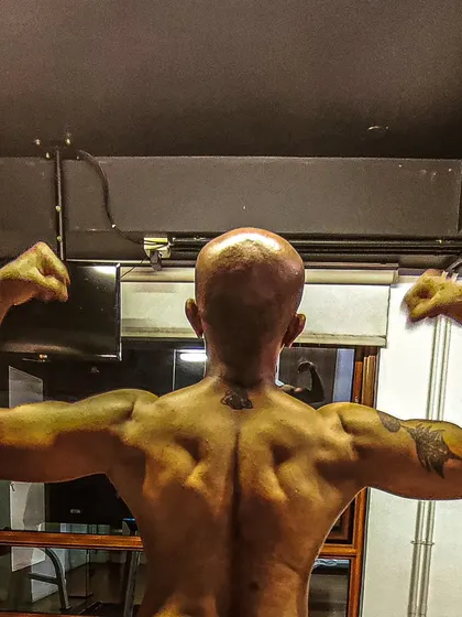 I believe in leading by example. This back-posing shot shows the result of years of natural bodybuilding and dedication to the fitness lifestyle that we preach and practice at our studio.