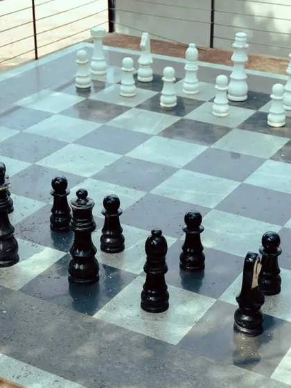 Our stunning outdoor chessboard is set against a backdrop of trees, offering a unique and memorable place to play.