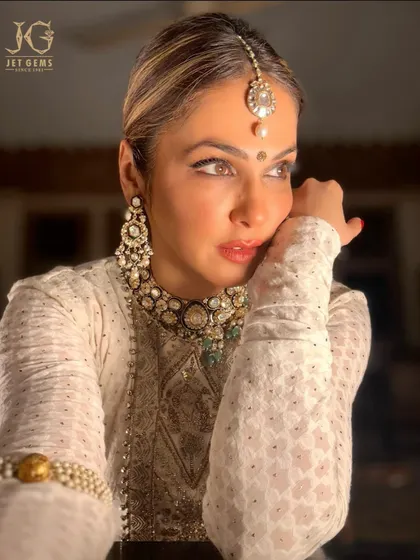 Lost in thought, adorned in legacy. This candid shot captures the timeless beauty of our Polki jewellery, a perfect heirloom for generations to come.