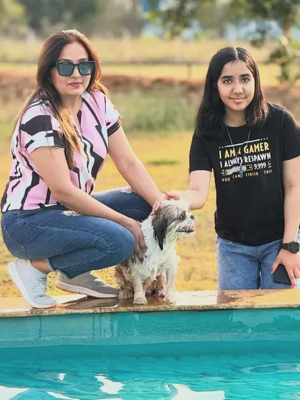 A mother and daughter enjoying a moment with their pup by the pool. Our camp is designed for families of all kinds.