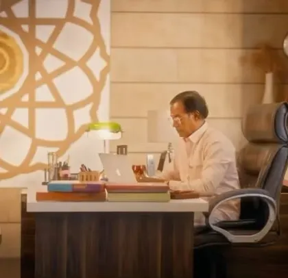 A still from a TV commercial, showing an actor in an office setting. I provide still photography on film sets to create a bank of images for promotional use.
