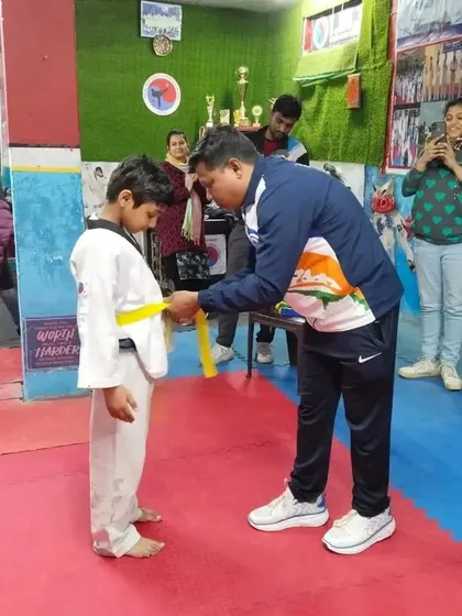 The belt ceremony is a proud moment for students and parents alike. Here I am awarding a new yellow belt.