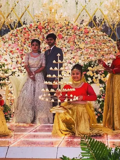 A beautiful, well-lit stage in Salem with our Diya welcome dancers posing with the happy couple. This is a perfect, classic shot for any wedding album.