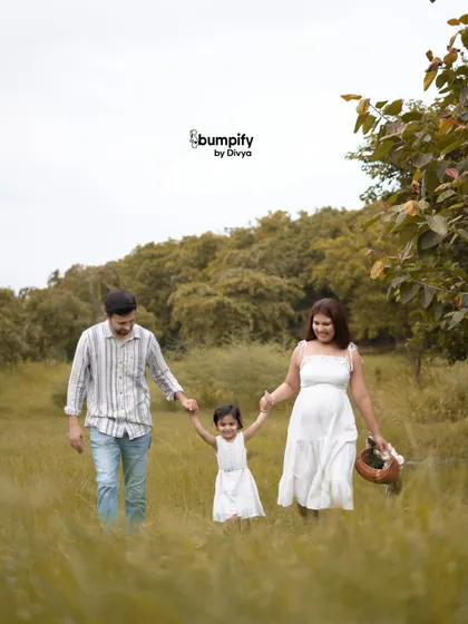 A happy family walk through a grassy field. Outdoor photoshoots are all about capturing movement, laughter, and the natural connection your family shares.