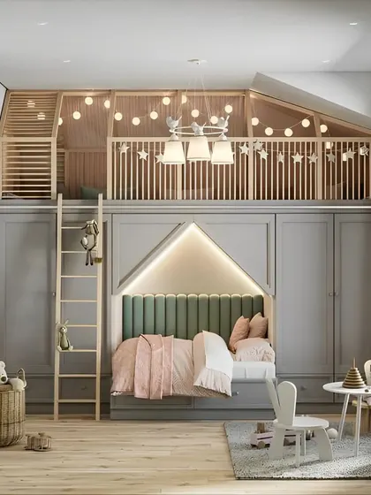 This elegant kids' room features a loft play area above a cozy, house-shaped bed nook. The sophisticated gray color scheme and warm string lights make it a space that can easily grow with the child.