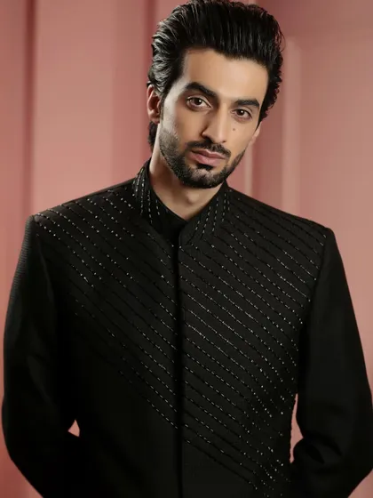 A portrait of confidence. The model wears our black beaded Indo-Western jacket, a piece that embodies classic dressing with a modern twist.