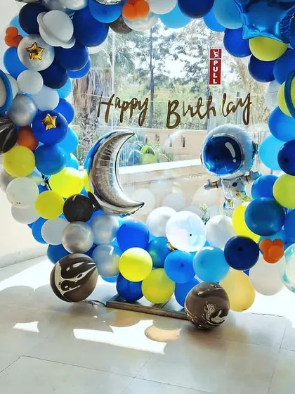 A closer look at the space-themed balloon wreath we created. We mixed in planet-themed foil balloons and a crescent moon to make this circular arch feel like a journey through the solar system.