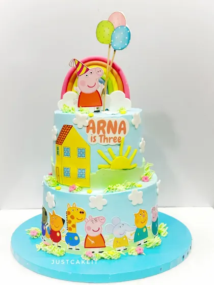 A two-tier Peppa Pig cake, perfect for a third birthday. The design is bright and cheerful, featuring Peppa's house and all her friends.