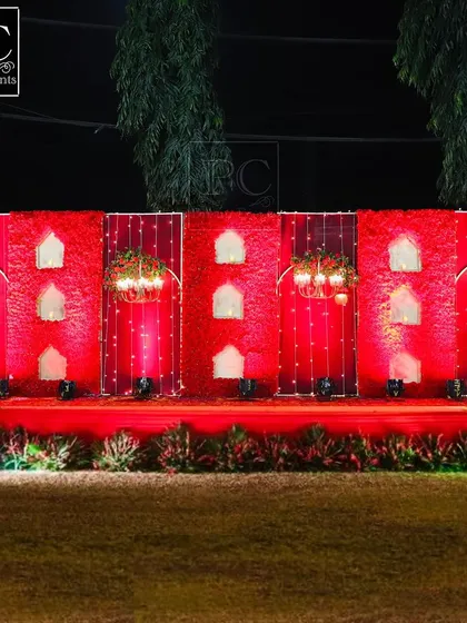 A full view of the magnificent red floral wall stage. The sheer scale and vibrant color make it an incredibly powerful and memorable backdrop for wedding photos.