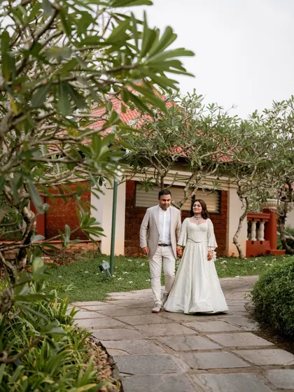 The couple sharing a moment on a pathway at the Caravela Beach Resort, hand in hand.