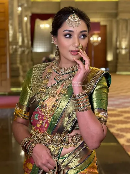 A beautiful three-quarter profile, highlighting the contour and eye makeup.