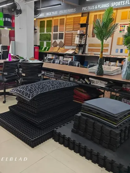 Inside my showroom, you can see displays of gym tiles, anti-skid mats, and a wide range of samples for deck tiles, ceiling panels, and sports flooring.