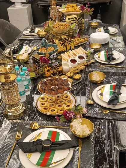 A luxurious high tea setup with an elaborate table setting. We provide everything from the food to the fine crockery and decor.