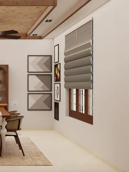The dining area in Bhuvana's home, featuring a gallery wall of abstract art and modern roman blinds. The design is all about creating a personalized and comfortable space.