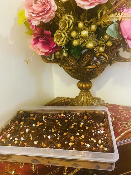Here is my Brownie Delight tray, ready for a party. It's decorated with chocolate piping, nuts, and star sprinkles to make it extra special.