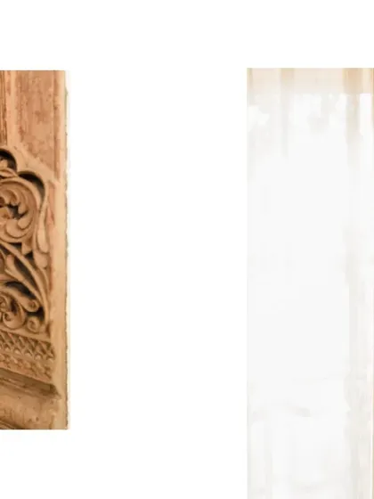 The contrast between the intricately carved wood and the rough texture of the exposed brick wall highlights the beauty of both materials.