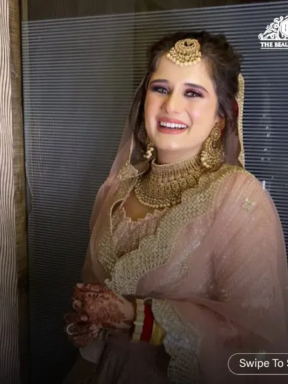 The complete look, with a sheer dupatta and a joyful expression. This is a perfect example of modern party makeup that is both elegant and fun.