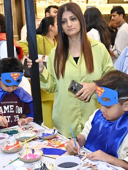 Little heroes concentrating on their creations at the craft table.