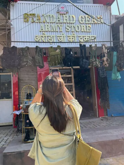 On a sourcing trip, always on the lookout for unique finds. Here I am exploring an army surplus store for some unconventional styling pieces.