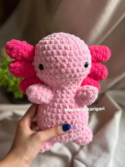 Our crochet axolotl is ready for a cuddle. Its sweet, simple face and plush body make it an adorable companion for kids and adults alike.