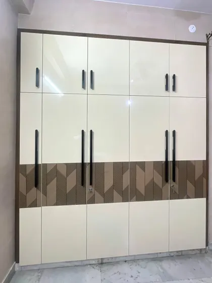 A full view of the dual-tone wardrobe. The design provides a mix of large and small cabinets to accommodate different storage needs.