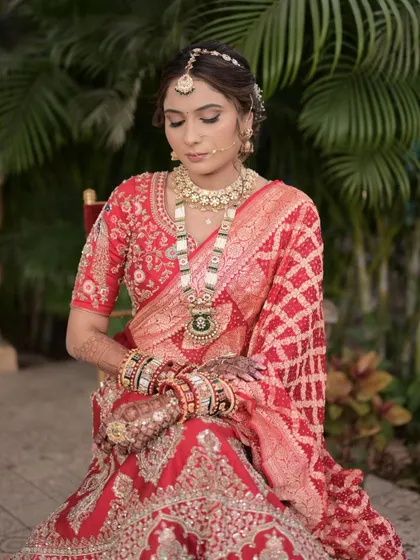 A serene portrait of the Gujarati bride, her hair neatly styled to showcase her beautiful features and traditional jewelry.