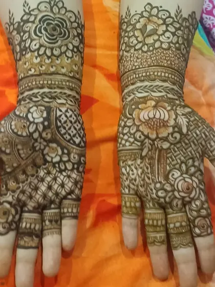 A mix of styles with a floral band at the wrist and a combination of geometric and paisley patterns on the hand.