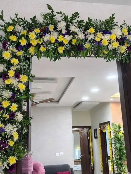 To continue the festive theme inside the home, I designed this beautiful floral arch for an internal doorway. The bright yellow and white chrysanthemums add a cheerful and welcoming feel to the space.