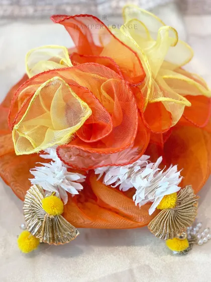 A close-up of the organza-draped hamper, highlighting the delicate fabric and the traditional tassels. It’s a beautiful example of how I combine textures and colors to create a festive feel.